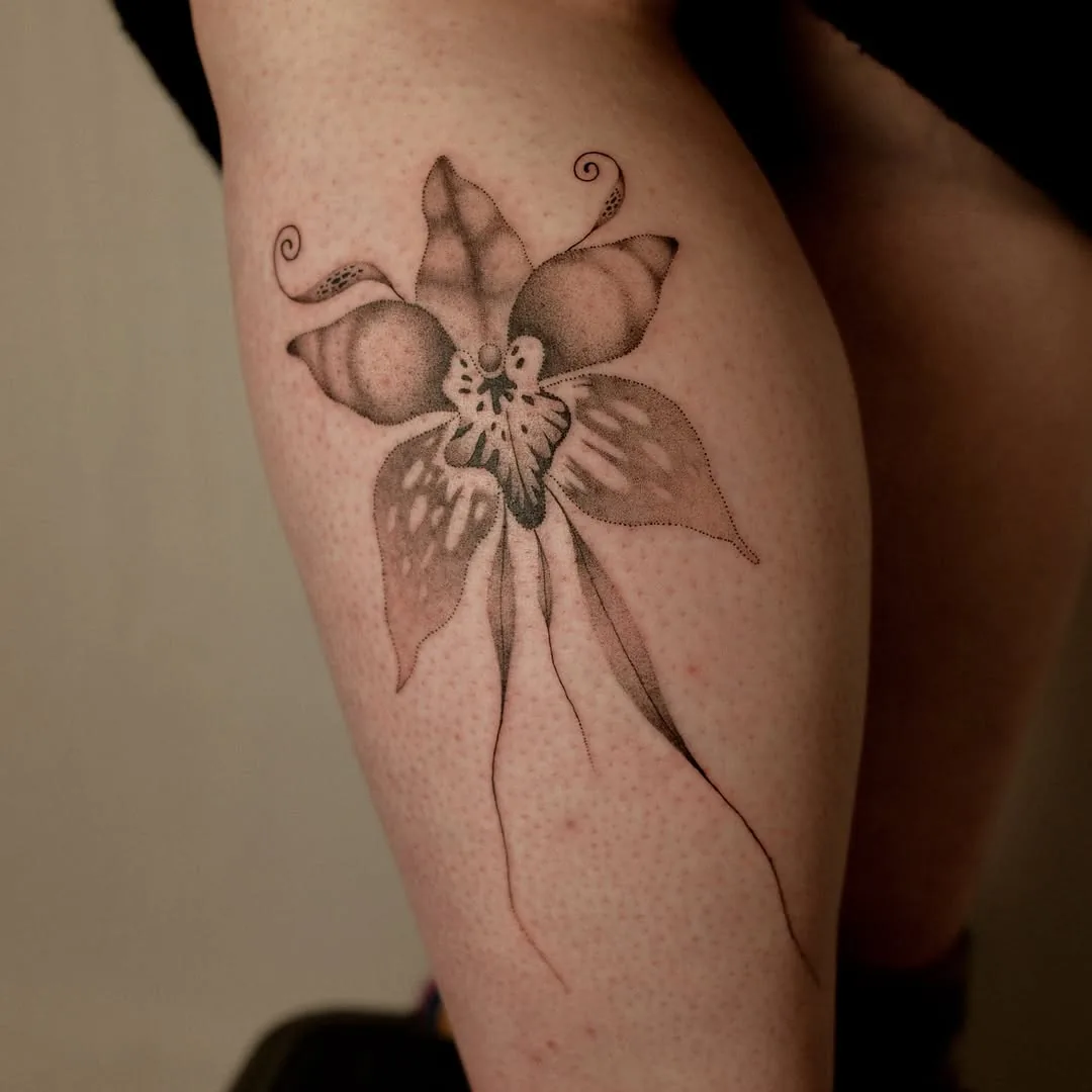 Dotwork alien orchid tattoo with curling tendrils on a calf