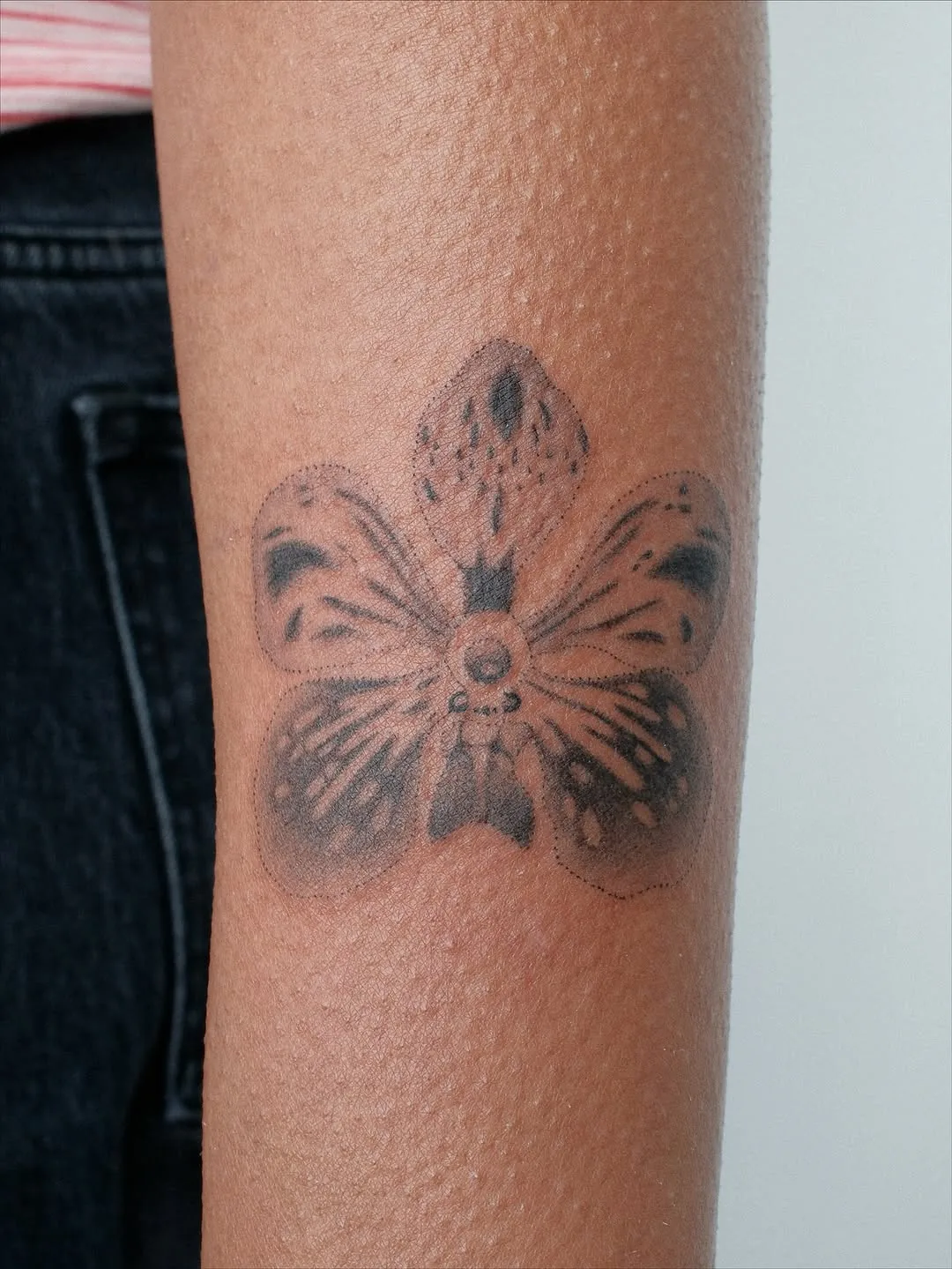 Orchid tattoo on a forearm
